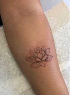 a woman's arm with a tattoo on it and a flower in the middle