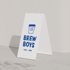 a sign that says brew boys in blue and white on the side of a wall