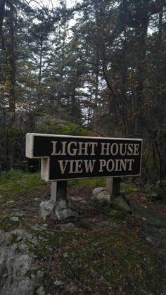 there is a sign that says light house view point on the side of a hill