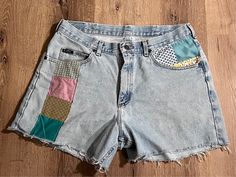 These Lee jean shorts have been cropped to 15 inches with a 4 inch inseam. Vintage quilt patches applied in front and back.  100% sustainable, circular fashion, one of a kind piece. Upcycled Denim Bottoms For Summer, Summer Upcycled Denim Bottoms, Retro Bottoms With Patches For Spring, Retro Spring Bottoms With Patches, Casual Bottoms With Patches In Recycled Denim, Casual Recycled Denim Bottoms With Patches, Summer Patchwork Recycled Denim Bottoms, Summer Recycled Denim Patchwork Bottoms, Patchwork Cotton Jean Shorts For Spring