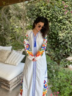 "This bohemian multicolour embroidery dress is a an eye catcher! It is an extremely comfortable wear, light and soft and can be used on many occasions - home gatherings, festival parties, summer occasions, dinners, or just in your home to feel comfortable. Fabric : 70% Egyptian Cotton; 30% Polyester. Kaftan measurements in inches : Medium (Size 8/10 USA) Bust : 39-40 Hip : 45-46 Large (Size 12/14 USA) Bust : 44-45 Hip : 50-51 XL (Size 16/18 USA) Bust : 47-48 Hip : 53-54 XXL (Size 20/22 USA) Bust Long Dress With Multicolor Embroidery For Spring, Bohemian Long Embroidered Dress For Spring, Spring Long Bohemian Embroidered Dress, White V-neck Embroidered Dress For Festival, Spring Long Sleeve Dress With Embroidered Border, Multicolor Chikankari Embroidery Dress For Eid, Spring Resham Embroidery Maxi Kurta, Traditional Maxi Dress With Multicolor Embroidery, Traditional Multicolor Embroidered Maxi Dress