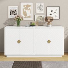 a white cabinet sitting in front of a wall filled with pictures and vases on top of it