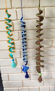 several different colored objects hanging on a brick wall