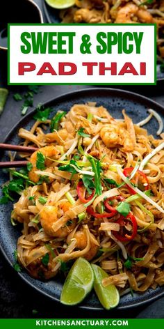 pad thai stir fry with shrimp and vegetables on a black plate next to lime wedges