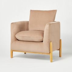 a beige chair with a wooden frame and cushion