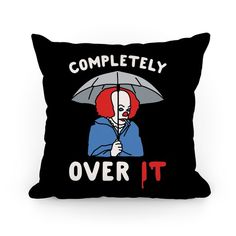 a pillow that says completely over it with a clown holding an umbrella in the rain