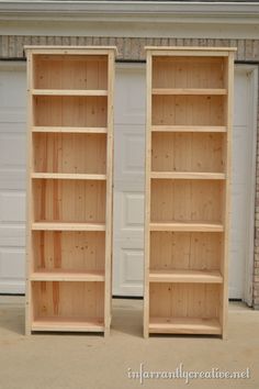 two wooden bookshelves sitting next to each other in front of a garage door