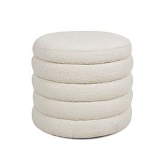 four white round pillows stacked on top of each other in front of a white background