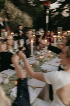 a group of people sitting around a dinner table