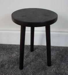 a black table sitting on top of a carpeted floor