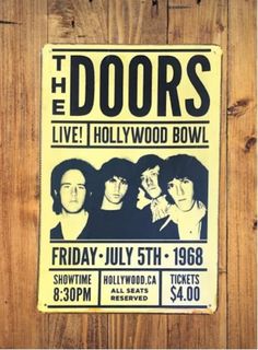 the doors concert poster hanging on a wooden wall