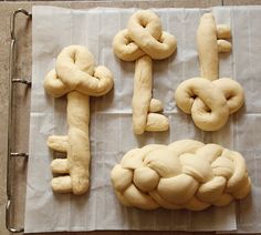 four different types of bread on top of a piece of wax paper with the word love spelled out