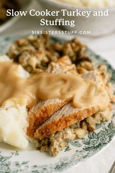 a plate topped with meat and gravy covered in gravy