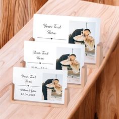 three wedding place cards with the same photo on them, sitting on a wooden table