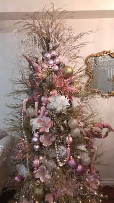 a decorated christmas tree with pink and silver ornaments