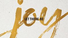 the words let there be written in gold paint