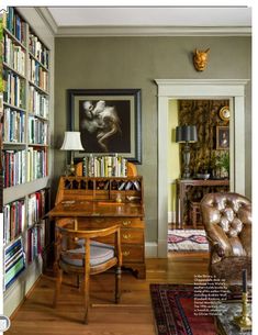 a living room filled with furniture and lots of books