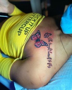 a woman with a butterfly tattoo on her stomach