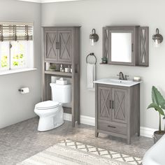 a white toilet sitting next to a sink in a bathroom