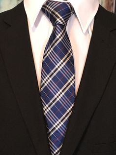 "For the man who loves plaid, Ed's Neckties offers this 100% silk mens plain necktie. Features a navy blue background with blue, gray and red plaid pattern. Available as a extra long tie. Handmade from 100% silk, this special collection features a .75\" Eds Neckties logo at the bottom right front corner of every tie and a larger logo located on the tipping (Back of the tie). The label features the collection name (Nathaniel Alexandria) Named after my son Nathaniel and my daughter Alexandria. Exp Navy Suit And Tie Accessories For Business, Classic Plaid Business Suit And Tie Accessories, Plaid Suit And Tie Accessories For Business, Fitted Plaid Ties, Make A Tie, White Goth, Plaid Tie, Tie Men's, Navy Blue Background