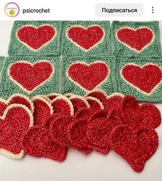 crocheted hearts are arranged in rows on a table