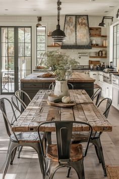 a wooden table sitting in the middle of a kitchen