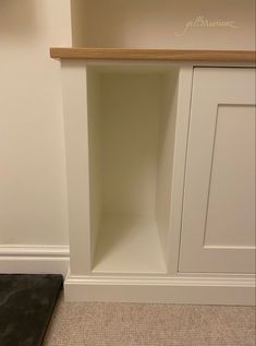 an empty shelf in the corner of a room