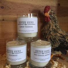 three candles sitting next to a chicken on some wood