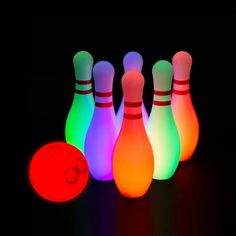 glowing bowling pins and ball in the dark