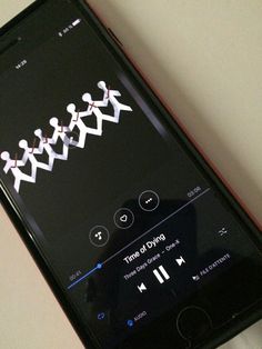 an iphone displaying the music player on its screen