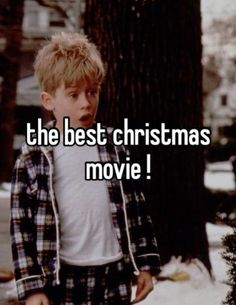 a young boy standing in front of a tree with the words the best christmas movie