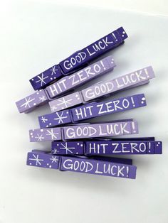 purple and white candy sticks with the words good luck written on them in different languages