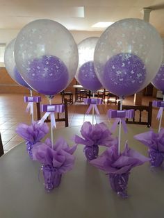 some purple and white balloons are on the table