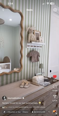 the baby's room is decorated with striped wallpaper and teddy bears on shelves