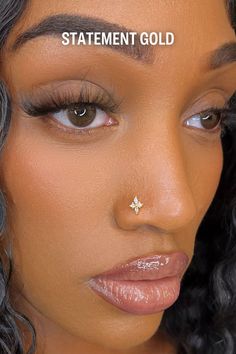 a close up of a woman with her nose piercing in the shape of a star