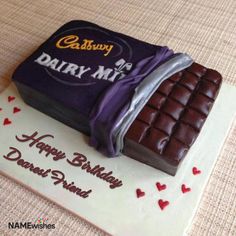 a birthday cake with chocolate on top and hearts around the edges that says dairy me