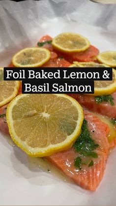 salmon with lemon slices and parsley on top in a white plate, ready to be eaten