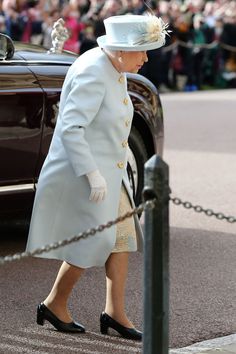 the queen of england is stepping out of her car