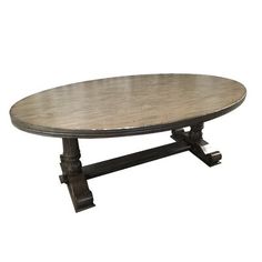 an oval wooden table with two legs and a circular top, sitting on a white background