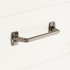 an image of a door handle on a white cabinet