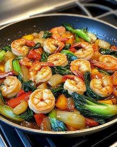 shrimp and vegetable stir fry in a wok on the stove