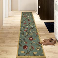 a blue floral runner rug with shoes on the floor