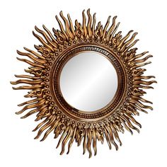 a gold sun mirror hanging on the wall