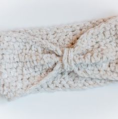 a close up of a knitted headband with a bow on it's side