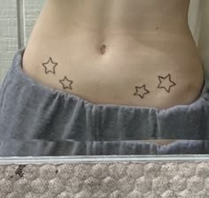 a woman's stomach with small stars on it