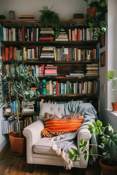 a living room filled with lots of books and plants