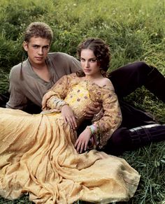 an old black and white photo of a man and woman laying on the ground together