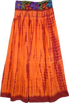 Red Orange Tie Dye Skirt - This beautiful Mexican red and Trinidad orange long skirt shows a true creative streak that will please you. It falls beautifully and looks astonishing with its tie dye and the bold yet intricate floral embroidery on the waistband. The waistband has contrast embroidery only on the front, the back is elasticized for flexibility and comfort. Spend your summer day shopping in this easy-to-wear tie dye skirt. You can complement with a crop top and similar sandals. This is Red Hippie Skirt For Summer, Red Festival Maxi Skirt For Spring, Hippie Red Maxi Skirt For Festivals, Hippie Style Red Maxi Skirt For Festivals, Spring Festival Red Maxi Skirt, Red Tiered Maxi Skirt For Festival, Red Flowy Maxi Skirt For Festival, Red Long Hippie Skirt, Red Hippie Flowy Maxi Skirt