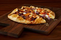 a pizza sitting on top of a wooden cutting board