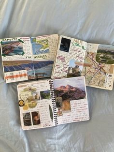 four notebooks with pictures and words on them sitting on a white sheet covered bed